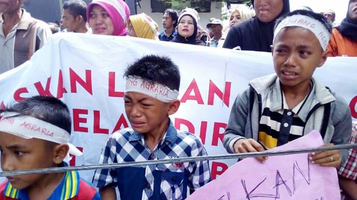 MENANGIS-Sejumlah anak terdakwa yang dituduh terlibat sebagai pelaku pembakar barak milik PT Fajar Baizury and Brothers, Rabu (4/5) siang menangis saat melakukan aksi unjukrasa di depan Pengadilan Negeri Meulaboh, Aceh Barat. Mereka berharap sang ayah dibebaskan karena tak terlibat sebagai pelaku pembakaran seperti yang dituduhkan.SERAMBI/TEUKU DEDI ISKANDAR 